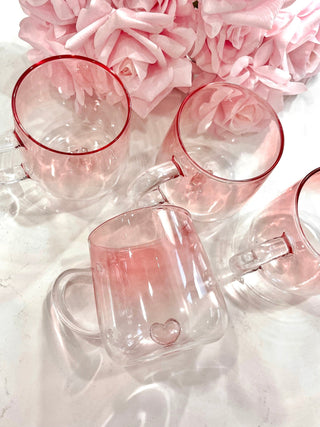 Four Heart You Glass Cups next to pink roses.