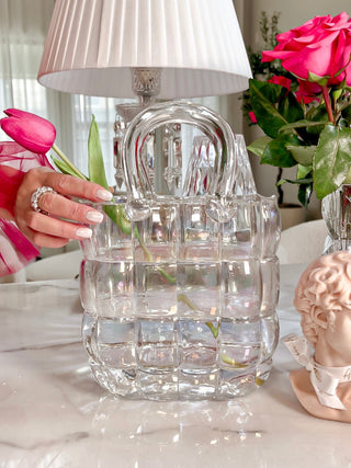 Camélia Padded Glass Handbag Vase in Rainbow decorated with one pink tulip atop a marble dining table.