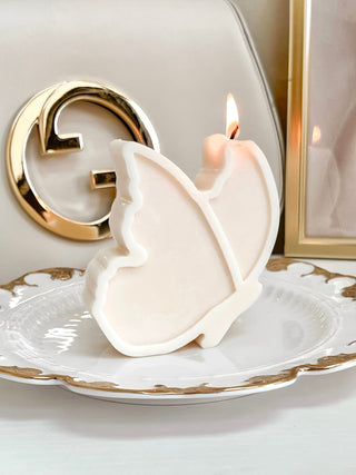Dreamy Butterfly Candle on gold plate.