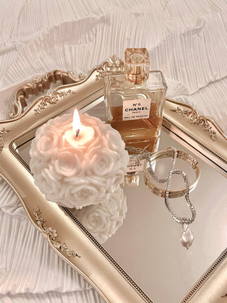 Grandeur Gold Mirror Tray with candles, perfume and jewelry on top.