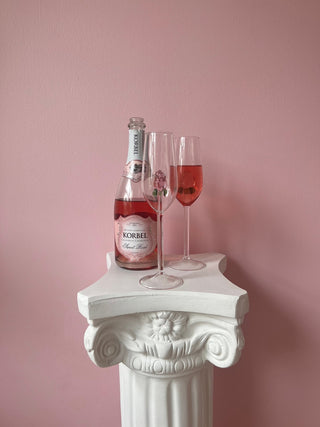 La Vie En Rose Champagne Glass Set of 2 atop a Greek column table with Rosé champagne.