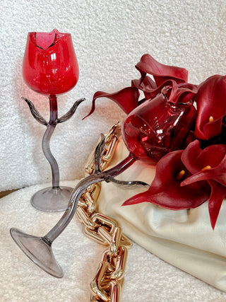 Rose For Rosé Glass Cup in Red set of 2 on a luxurious fabric sofa next to bloomed red flowers and gold chained bag.