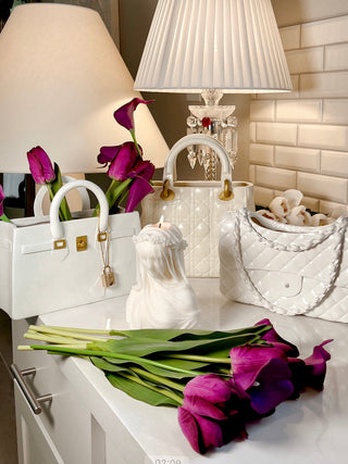 Scarlett Handbag Resin Vase in Beige surrounded by other luxurious resin vases.